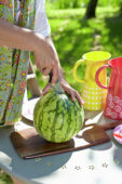 Woman cutting watermelon