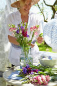 Woman arranging summer bouquet