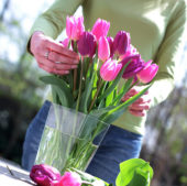 Woman arranging tulip bouquet