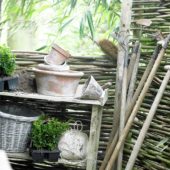Potting table and tools against willow fence