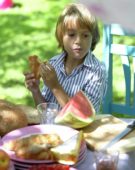 Boy eating croissant