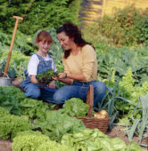 Mother and daughter in vegetable garden