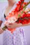 Lady holding mixed bunch of Flamencos gladioli, Forever Bulbs, Gladiolus Ted's Frizzle