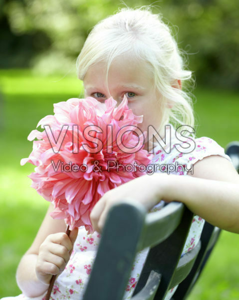 Girl holding dahlia