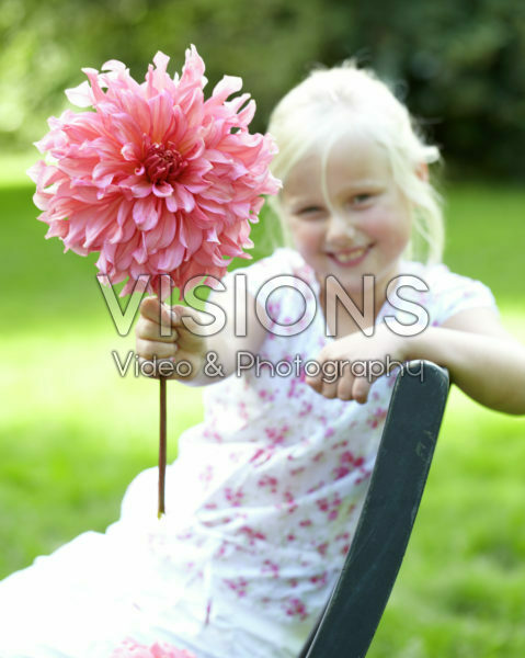 Girl holding dahlia