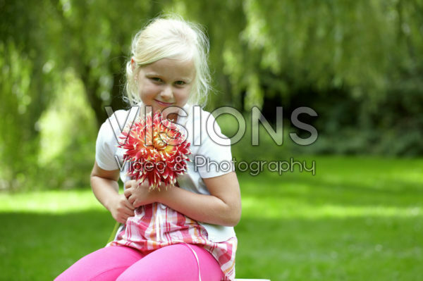 Girl holding dahlia