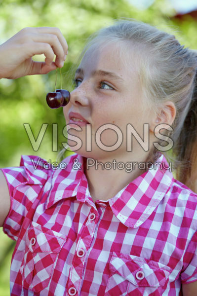 Girl eating cherries