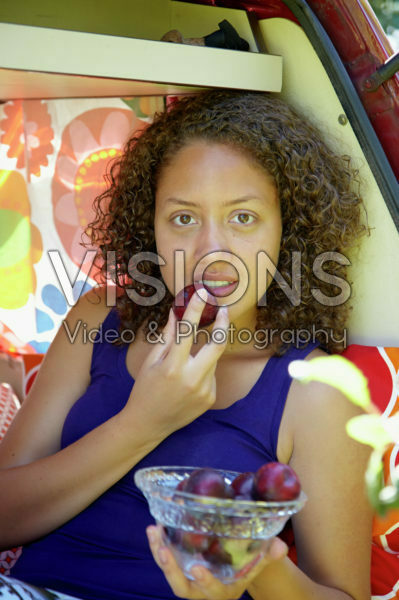 Girl eating plum Girl eating plum