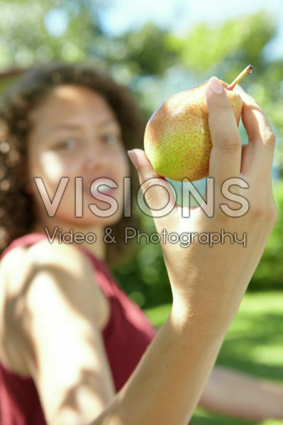 Girl holding pear