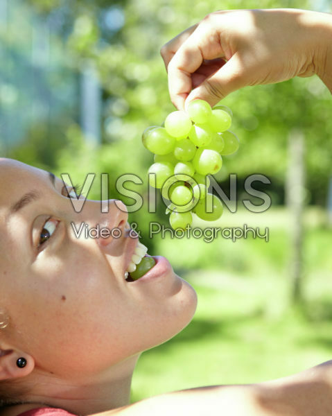 Girl eating grapes