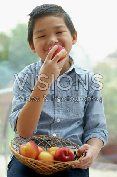 Boy eating nectarine