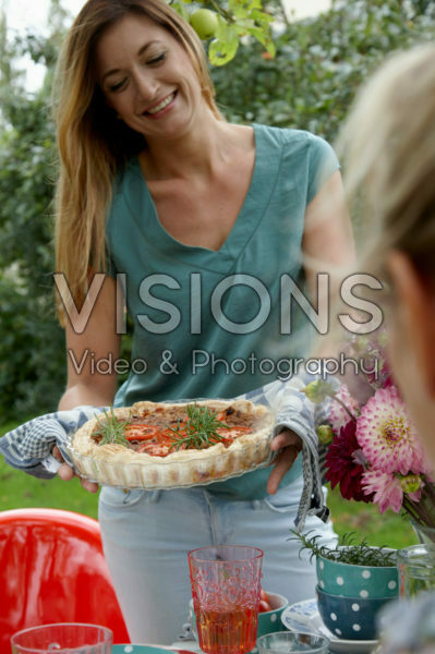 Lady serving tomato quiche