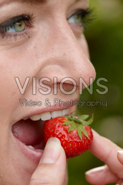 Lady eating strawberry