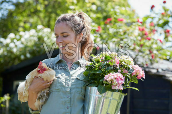 Lady holding hydrangea and chicken