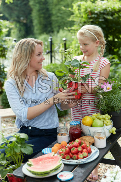Mother and daughter with strawberries