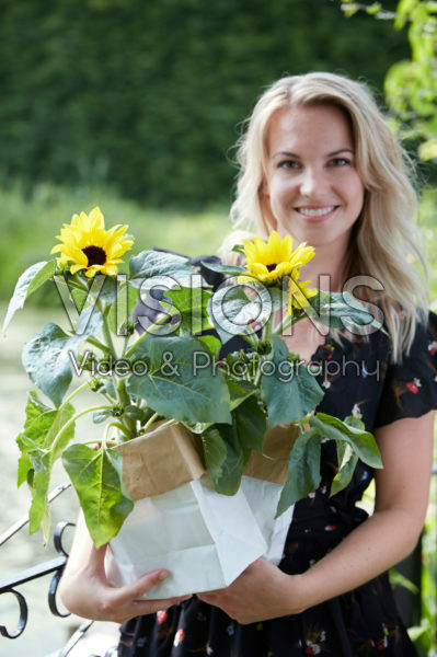 Lady holding sunflowers
