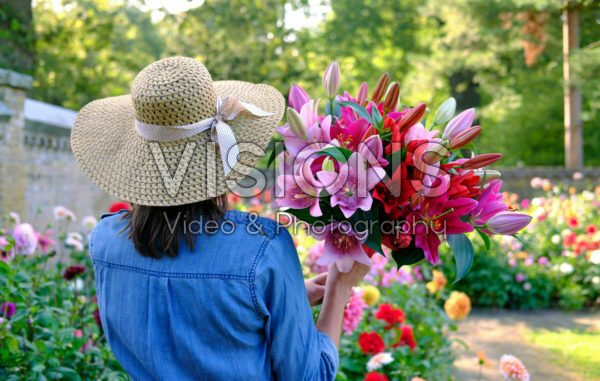 Lady holding bunch of lilies