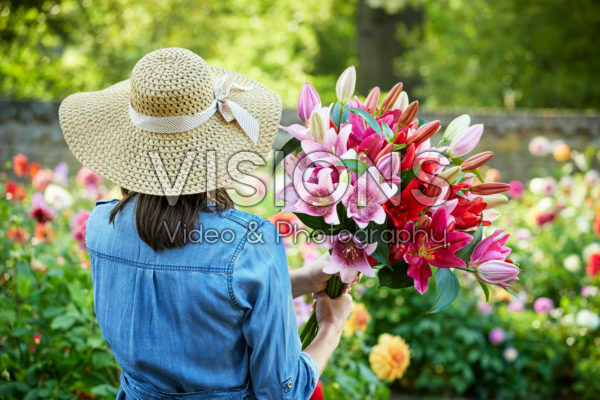 Lady holding bunch of lilies