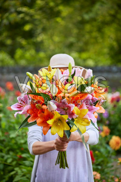 Lady holding bunch of lilies
