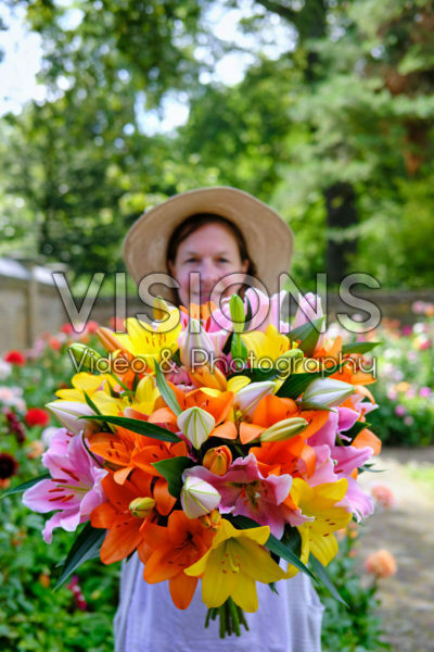 Lady holding bunch of lilies