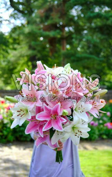 Lady holding bunch of lilies Lady holding bunch of lilies