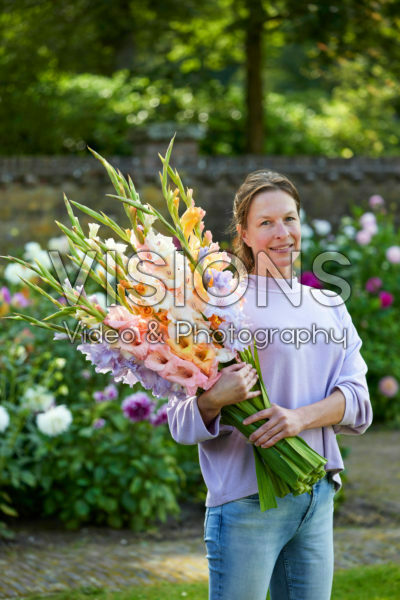 Lady holding bunch of gladioli Lady holding bunch of gladioli