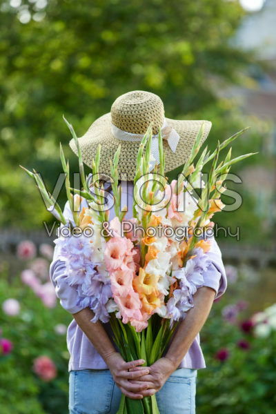 Lady holding bunch of gladioli Lady holding bunch of gladioli