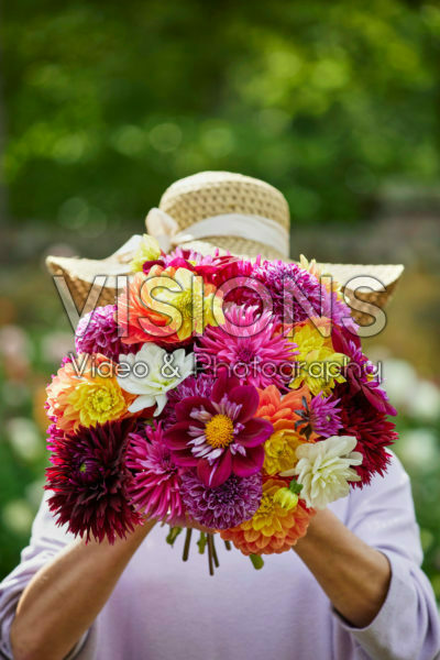 Lady holding bunch of dahlias
