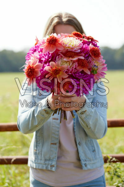 Lady holding bunch of dahlias Lady holding bunch of dahlias