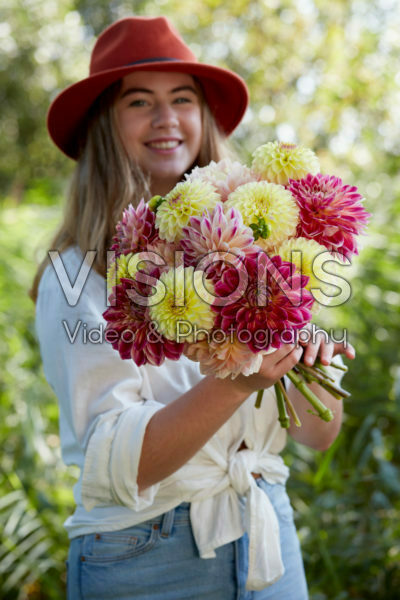 Lady holding bunch of dahlias