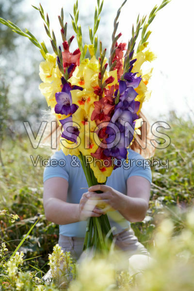 Lady holding bunch of gladioli Lady holding bunch of gladioli