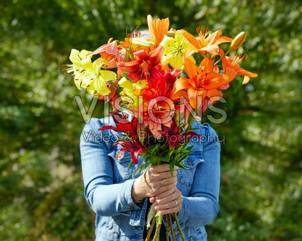 Lady holding bunch of lilies
