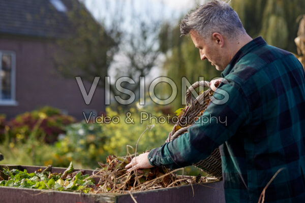 Adding leaves to compost heap