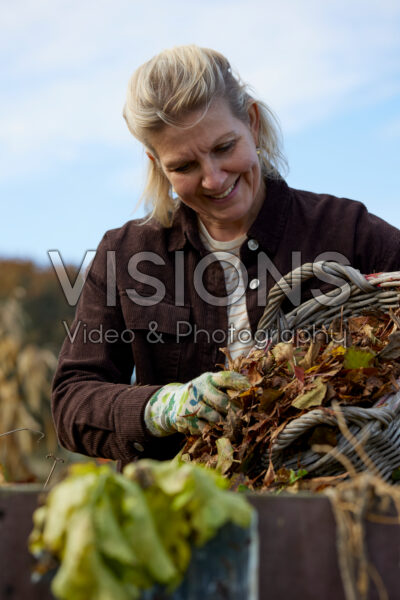 Adding leaves to compost heap