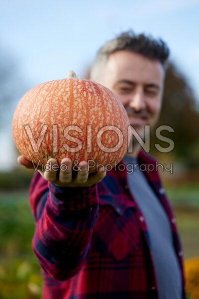 Man holding pumpkin