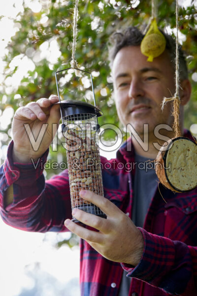 Filling bird feeder Filling bird feeder