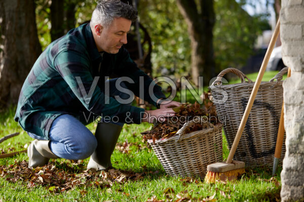 Man collecting fallen leaves