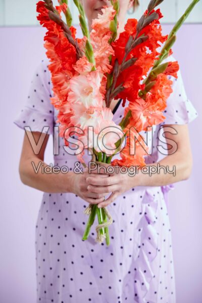 Lady holding mixed bunch of Flamencos gladioli Lady holding mixed bunch of Flamencos gladioli