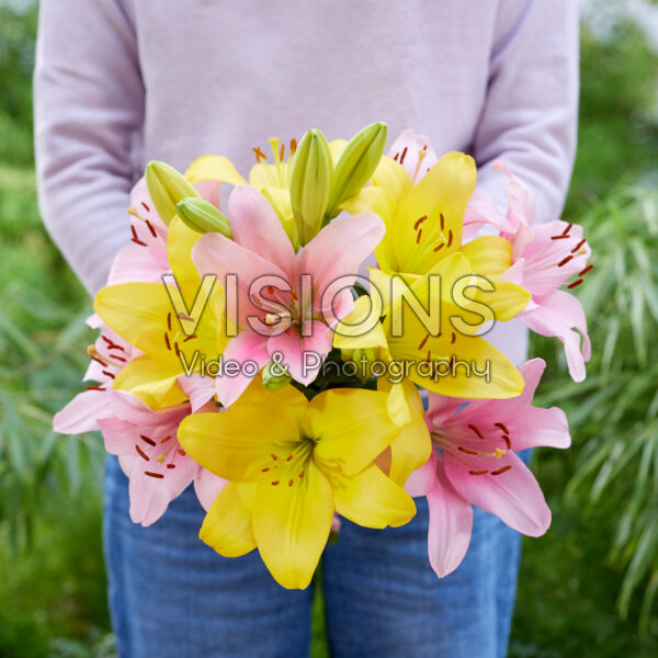 Lady holding bunch of lilies