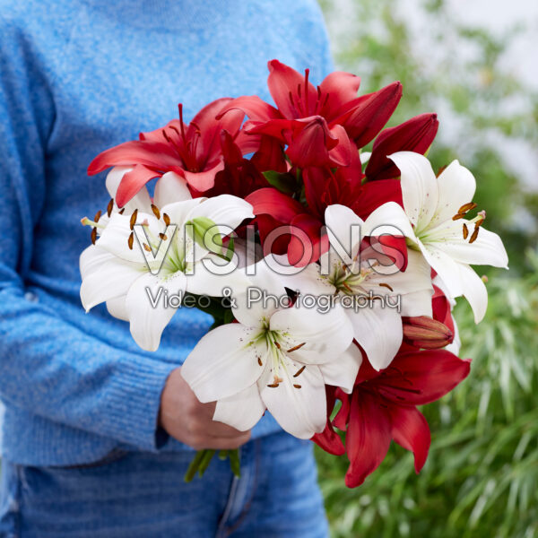 Lady holding bunch of lilies