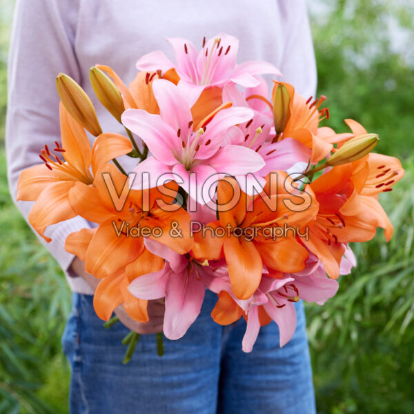 Lady holding bunch of lilies