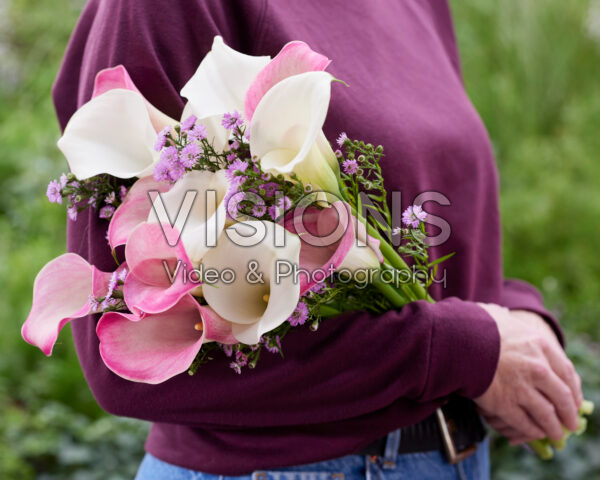 Lady holding mixed calla bouquet