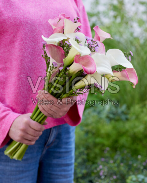 Lady holding mixed calla bouquet