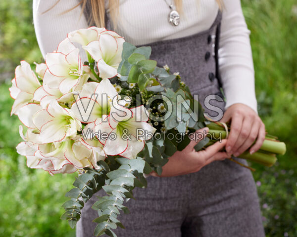 Lady holding amaryllis bouquet