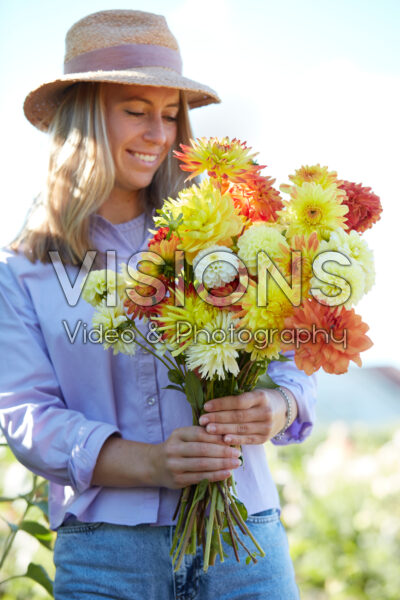 Lady with colourful mixed dahlia bouquet Lady with colourful mixed dahlia bouquet