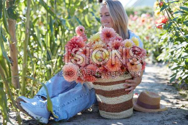Lady with basket of mixed dahlias