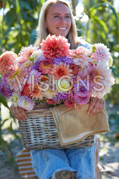 Lady with basket of mixed dahlias Lady with basket of mixed dahlias