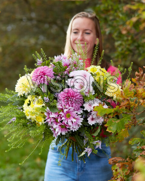 Lady holding mixed bouquet of chrysanthemums