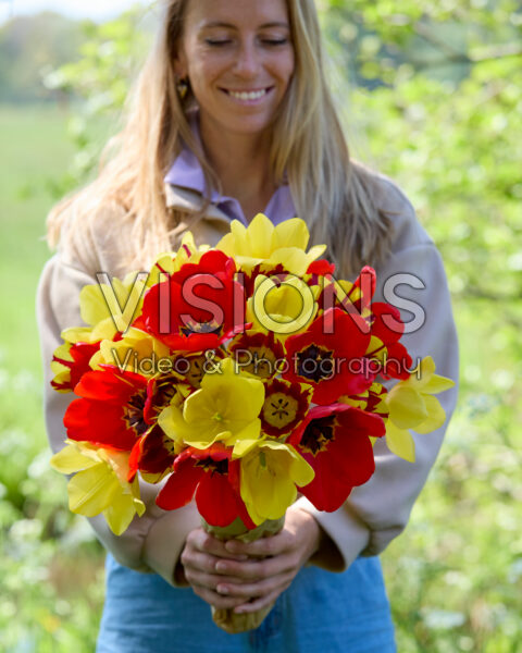 Lady with mixed tulip bouquet red and yellow Lady with mixed tulip bouquet red and yellow