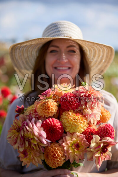 Lady with mixed dahlia bouquet